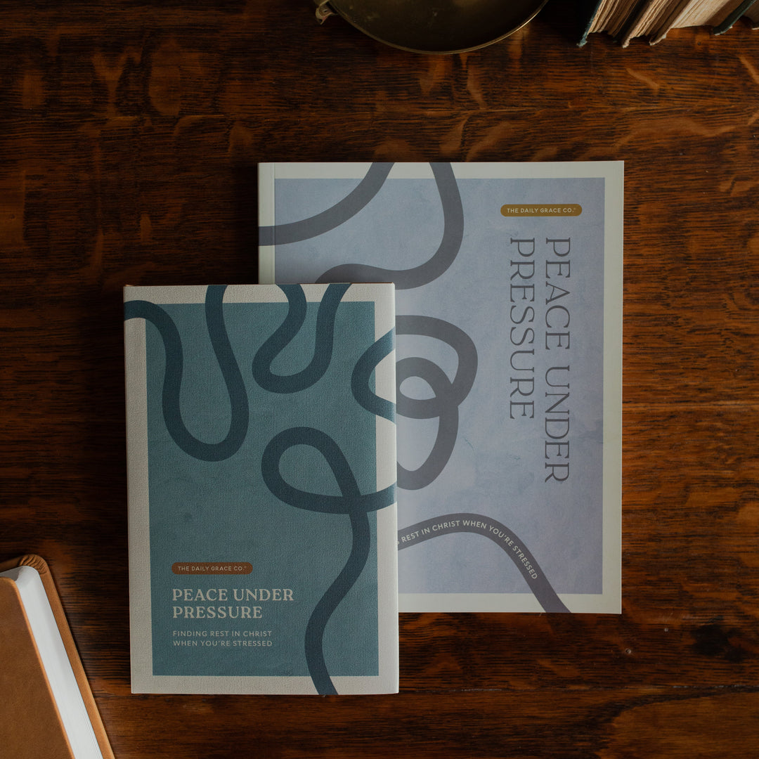 Peace Under Pressure Men and Womens Study cover on a wooden table  next to a journal